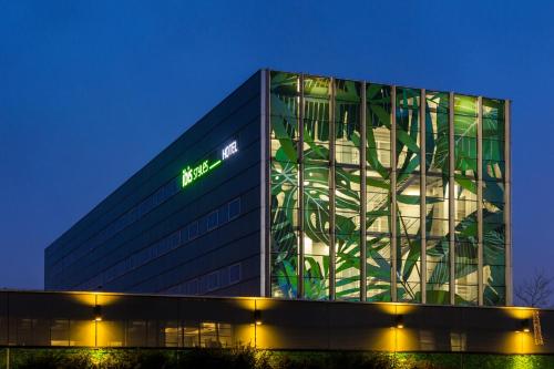 a building with a sign on the side of it at ibis Styles Amsterdam Airport in Schiphol