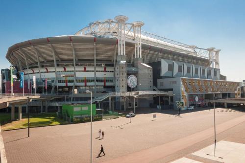 a large stadium with a clock on the side of it at ibis Styles Amsterdam Airport in Schiphol