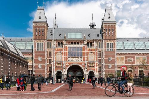 a large brick building with people riding bikes in front at ibis Styles Amsterdam Airport in Schiphol