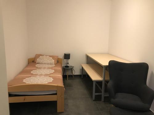 a room with two beds and a desk and a chair at Monteurwohnung 1 in Ingelheim am Rhein