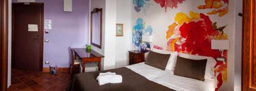 a bedroom with a bed with a painting on the wall at Tenuta Terre dei Latini in Segni