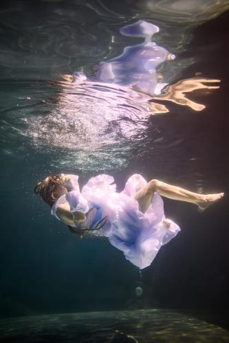 a woman in a dress floating in the water at Vermieterei in Oberwölbling