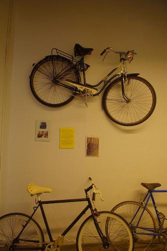 two bikes are hanging on a wall at All Iron Hostel in Bilbao