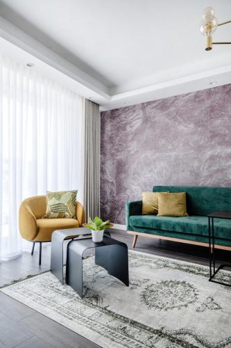 a living room with a couch and a table at Million Sunsets Luxury Apartments in St. Paul's Bay