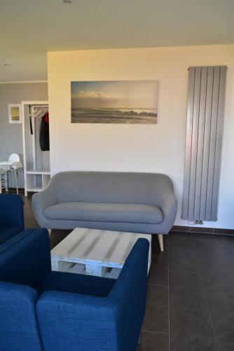 a living room with a couch and a table at MOIN & AHOI Ferienwohnung in Boiensdorf