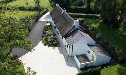 an aerial view of a white house with a roof at Rosies Cottage in Maghera