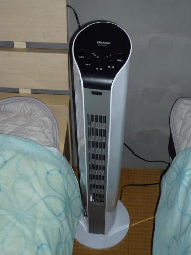 a computer tower sitting on a stand next to a bed at Futami Terrace B in Ise