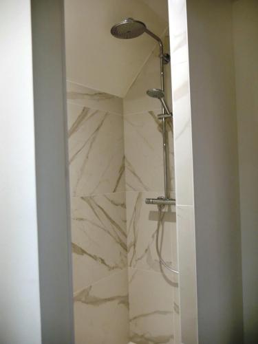 a bathroom with a shower with a marble wall at KastellRen - Rennes - Grand parking privé in Rennes