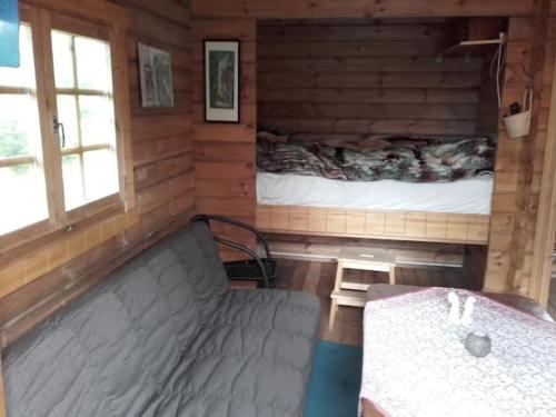 a room with a bed in a log cabin at Arngrimslundur log cabin - cabin 3 in Fludir