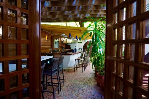 a kitchen with chairs and a table and a plant at At Wind Chimes Boutique Hotel in San Juan