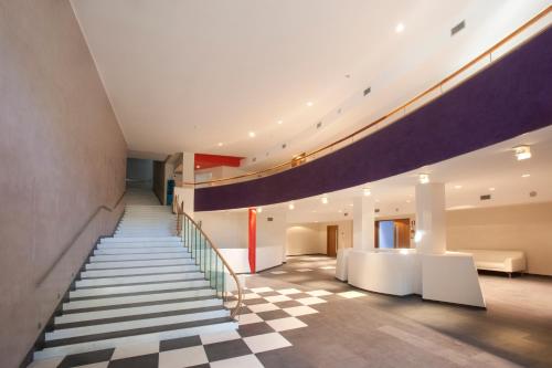a staircase in a building with a checkerboard floor at Arthotel & Park Lecce in Lecce