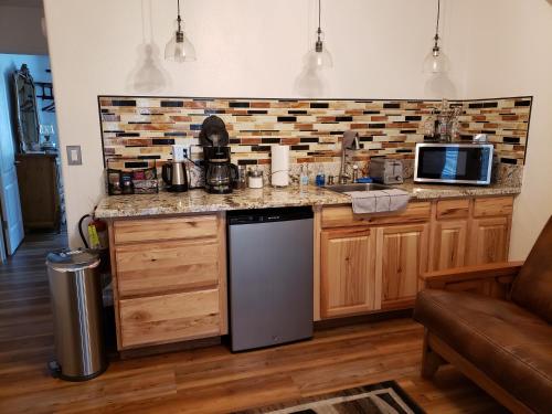 a kitchen with a counter with a sink and a microwave at Yosemite Foothill Retreat - Private Guest Suite #2 in Coarsegold