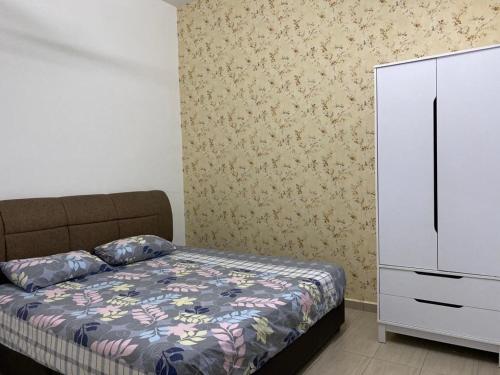 a bedroom with a bed and a white dresser at Homestay ayer keroh mitc in Melaka