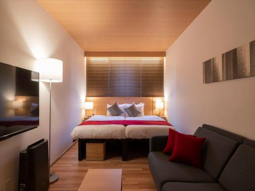 Postel nebo postele na pokoji v ubytování TORIFITO HOTEL&POD NISEKO