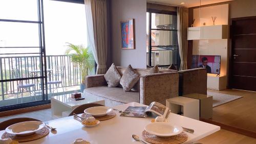 a living room with a couch and a table at luxury high floor loft pool condo with 2 bedrooms in Chiang Mai