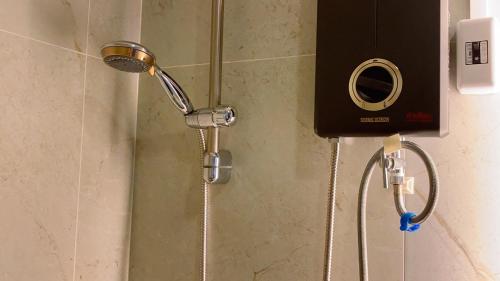 a shower with a shower head in a bathroom at luxury high floor loft pool condo with 2 bedrooms in Chiang Mai