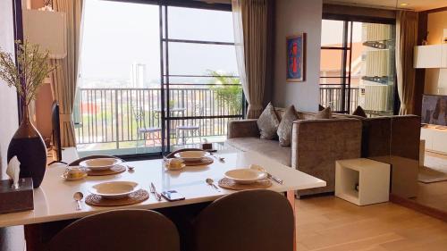 a living room with a table and a couch at luxury high floor loft pool condo with 2 bedrooms in Chiang Mai