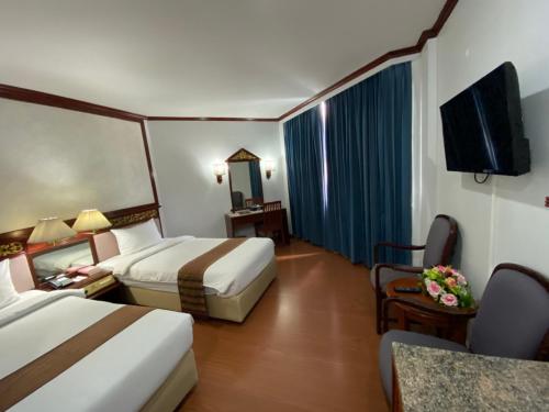 Кровать или кровати в номере Wangcome Hotel