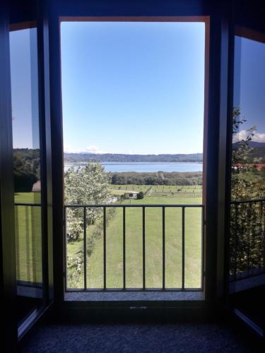a room with a window with a view of a field at Equirelais in Varese