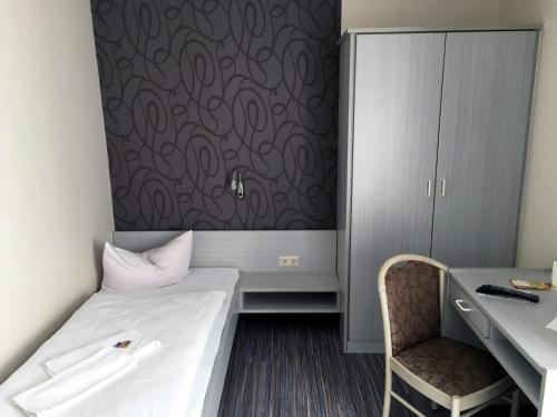 Ένα ή περισσότερα κρεβάτια σε δωμάτιο στο Hotel Landsknecht