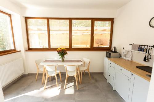 a kitchen with a table and chairs in a room at Horský dom Apartmány in Levoča