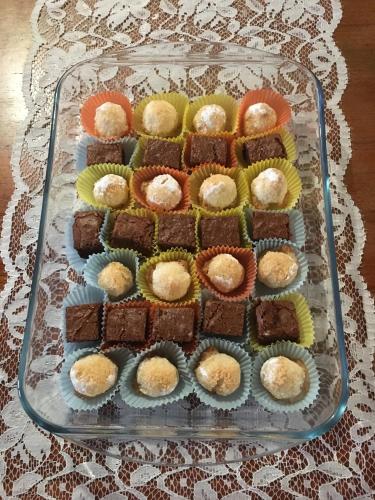 a glass tray filled with brownies and cupcakes at Portale dei Soli - Room & Breakfast in Rolo