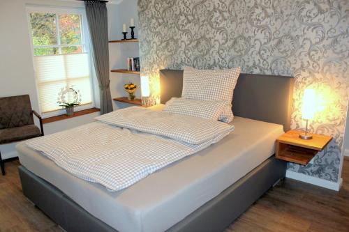 a bedroom with a bed and a chair and a table at DZ/EZ Lodberger Scheunencafe in Löningen