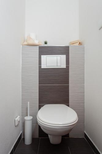 a bathroom with a white toilet in a room at Tři smrčky in Ostravice