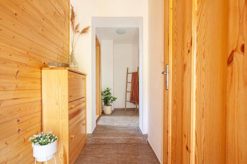 a hallway of a house with wooden walls and a door at Tři smrčky in Ostravice