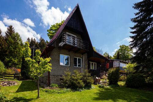 a house with a gambrel roof at Tři smrčky in Ostravice