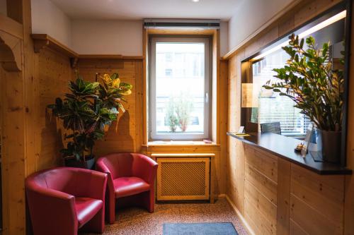 a room with two chairs and a window at Pension am Heusteig in Stuttgart