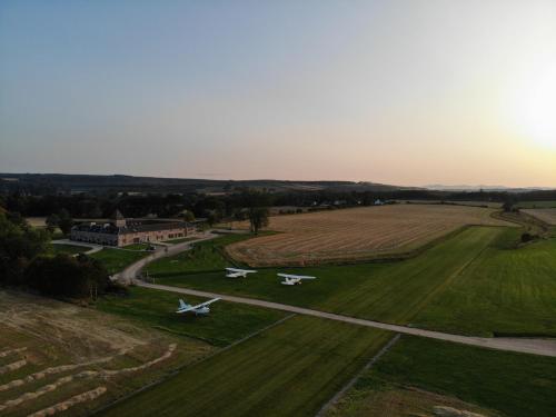 two planes are parked on a runway in a field at Newhall Mains in Resolis