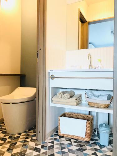 a bathroom with a sink and a toilet at Shooting Star the Bed & Breakfast in Furano