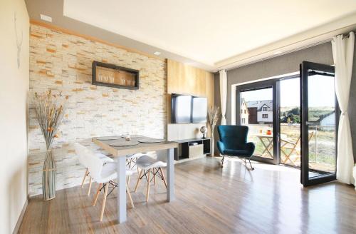 a living room with a dining room table and chairs at SCANDIC Apartments Boží Dar in Boží Dar