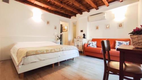 a bedroom with a bed and a couch at B&B ai Musei in Brescia