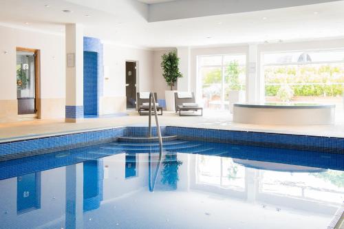 a swimming pool with a tub in a house at Lakeside Park Hotel & Spa in Ryde