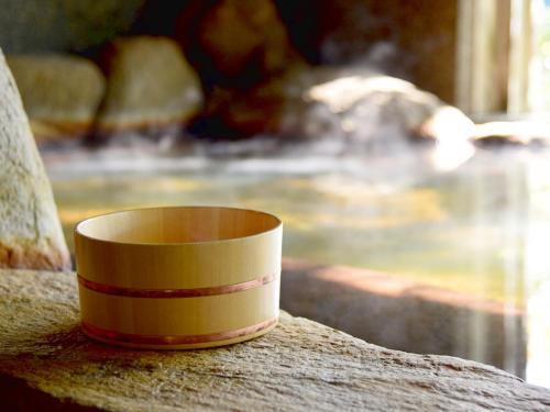 a yellow and red cup sitting on top of a table at Kohanyu in Kami