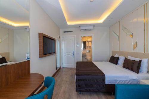 a hotel room with a bed and a television at The Byzantium Suites Hotel & Spa in Istanbul