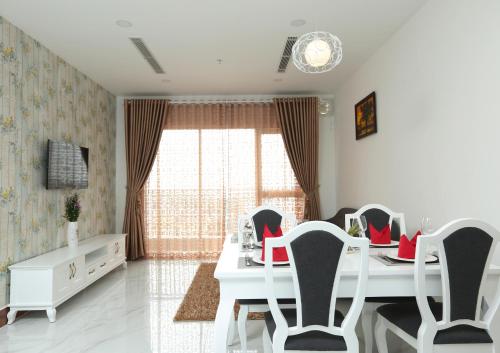 a room with a table and chairs and a window at The Mira Boutique Hotel in Thu Dau Mot