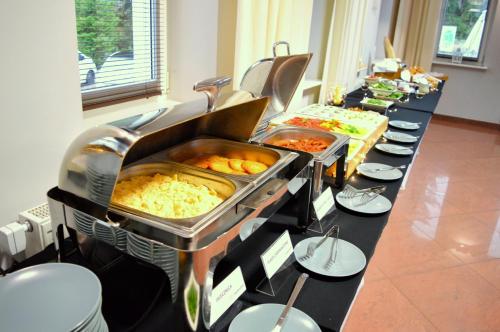 a long buffet line with many different types of food at Tailor Hotel Sport & Conference in Morąg