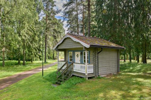 a small house in the middle of a field at First Camp Mellsta-Borlänge in Borlänge