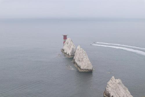 two rocks in the water with a lighthouse on them at Lakeside Park Hotel & Spa in Ryde