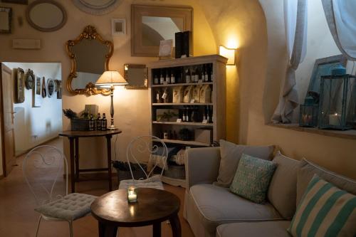a living room with a couch and a table at Ex Convento Santa Croce-Country resort in SantʼAnatolia di Narco