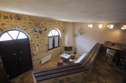 a room with a staircase and a door and a table at ΕΥμορφο σαν παραμύθι ΑΜΥΓΔΑΛΙΑ in Amfiklia