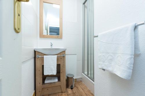 a bathroom with a sink and a mirror at Résidence Odalys Les Chalets de l'Arvan II in Saint-Sorlin-dʼArves