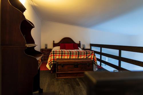 a bedroom with a bed with red pillows on it at Refugio no Campo - AL 1683 in Rapoula do Côa