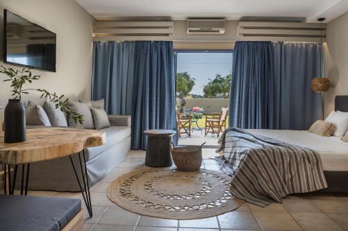 a living room with a bed and a couch at Avithos Resort Hotel in Svoronata