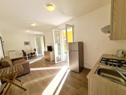 a kitchen with a refrigerator and a living room at Santa Caterina in Levanto