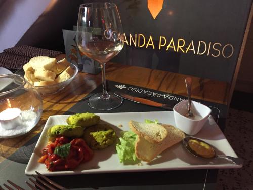 a plate of food on a table with a glass of wine at La Locanda Paradiso in SantʼEgidio