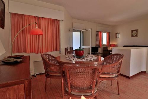 een woonkamer met een tafel en stoelen en een keuken bij Casa Vale do Lobo 114 - Great Townhouse few minutes walk from Beach Praca in Vale do Lobo